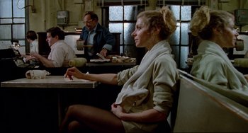 Movie still from “All That Jazz” (1979), directed by Bob Fosse – A woman sitting at a table in front of a man; Medium shot, Over the shoulder angle