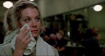 Movie still from “All That Jazz” (1979), directed by Bob Fosse – A woman wiping her face with a white towel; Close Up shot, Over the shoulder angle