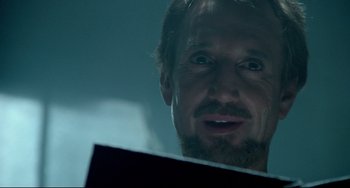 Movie still from “All That Jazz” (1979), directed by Bob Fosse – A person with a beard looking at a mirror; Close Up shot, Low angle