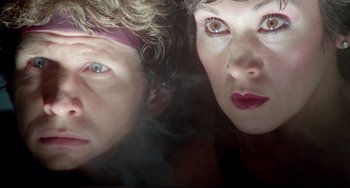 Movie still from “All That Jazz” (1979), directed by Bob Fosse – A woman and a man are posing for a picture; Close Up shot, Low angle