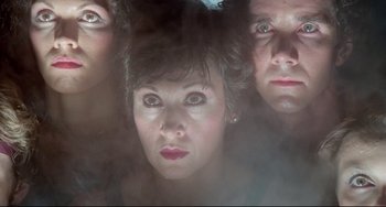 Movie still from “All That Jazz” (1979), directed by Bob Fosse – A woman and two men looking at the camera; Close Up shot, Low angle