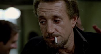 Movie still from “All That Jazz” (1979), directed by Bob Fosse – A person with a cigarette in his mouth; Close Up shot, Low angle