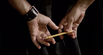 Movie still from “All That Jazz” (1979), directed by Bob Fosse – A person holding a measuring tape in their hands; Extreme Close Up shot, Low angle