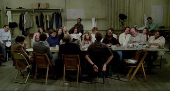Movie still from “All That Jazz” (1979), directed by Bob Fosse – A group of people sitting around a table; Wide shot, High angle