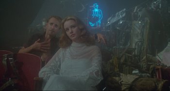 Movie still from “All That Jazz” (1979), directed by Bob Fosse – A man and a woman are sitting in front of a neon sign; Medium shot, Low angle