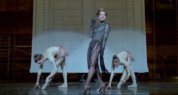 Movie still from “All That Jazz” (1979), directed by Bob Fosse – A group of dancers performing on a stage; Wide shot, Low angle