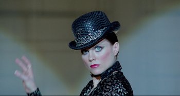 Movie still from “All That Jazz” (1979), directed by Bob Fosse – A woman wearing a black hat and a black lace dress; Close Up shot, Low angle