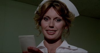 Movie still from “All That Jazz” (1979), directed by Bob Fosse – A woman in a nurse's uniform holding a cell phone; Close Up shot, Low angle