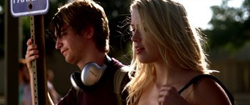 Movie still from “All the Boys Love Mandy Lane” (2006), directed by Jonathan Levine – A man and a woman are standing together with headphones on their ears; Close Up shot, Low angle