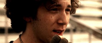 Movie still from “All the Boys Love Mandy Lane” (2006), directed by Jonathan Levine – A person with a microphone; Close Up shot, High angle