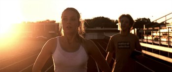 Movie still from “All the Boys Love Mandy Lane” (2006), directed by Jonathan Levine – A woman is running on a track at sunset; Close Up shot, Low angle