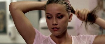 Movie still from “All the Boys Love Mandy Lane” (2006), directed by Jonathan Levine – A young woman is looking down at her hair; Close Up shot, Low angle