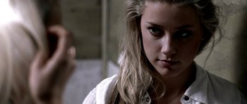 Movie still from “All the Boys Love Mandy Lane” (2006), directed by Jonathan Levine – A person with long blonde hair; Close Up shot, Over the shoulder angle