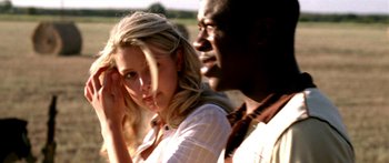 Movie still from “All the Boys Love Mandy Lane” (2006), directed by Jonathan Levine – A woman standing next to a man in front of a field; Close Up shot, Over the shoulder angle