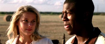 Movie still from “All the Boys Love Mandy Lane” (2006), directed by Jonathan Levine – A man and a woman standing next to each other in a field; Close Up shot, Over the shoulder angle