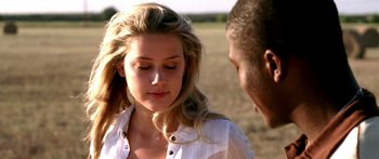 Movie still from “All the Boys Love Mandy Lane” (2006), directed by Jonathan Levine – A man and a woman standing next to each other in a field; Close Up shot, Over the shoulder angle