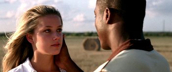 Movie still from “All the Boys Love Mandy Lane” (2006), directed by Jonathan Levine – A man and a woman in the middle of an open field; Close Up shot, Over the shoulder angle