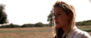 Movie still from “All the Boys Love Mandy Lane” (2006), directed by Jonathan Levine – A beautiful young blonde woman looking off into the distance in an open field; Close Up shot, Over the shoulder angle