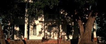 Movie still from “All the Boys Love Mandy Lane” (2006), directed by Jonathan Levine – A white building with a tree in front of it; Extreme Wide shot, Low angle