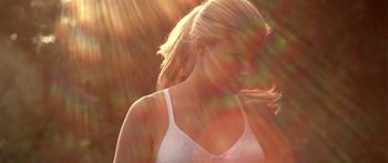 Movie still from “All the Boys Love Mandy Lane” (2006), directed by Jonathan Levine – A woman in a white tank top is standing in the sunlight; Close Up shot, Low angle