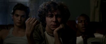 Movie still from “All the Boys Love Mandy Lane” (2006), directed by Jonathan Levine – A man with curly hair is smoking a cigarette; Close Up shot, High angle