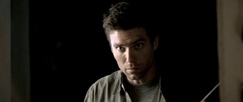 Movie still from “All the Boys Love Mandy Lane” (2006), directed by Jonathan Levine – A person wearing a gray shirt; Close Up shot, Low angle