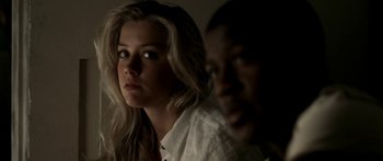 Movie still from “All the Boys Love Mandy Lane” (2006), directed by Jonathan Levine – A woman and a man are looking at the camera; Close Up shot, Over the shoulder angle