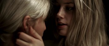 Movie still from “All the Boys Love Mandy Lane” (2006), directed by Jonathan Levine – Two women are looking at one another in a dark room; Extreme Close Up shot, Over the shoulder angle