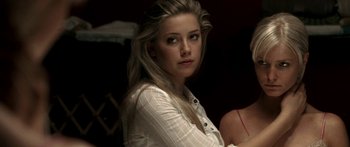 Movie still from “All the Boys Love Mandy Lane” (2006), directed by Jonathan Levine – A beautiful young lady wearing a white shirt and sitting in a chair; Close Up shot, Over the shoulder angle