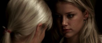 Movie still from “All the Boys Love Mandy Lane” (2006), directed by Jonathan Levine – A woman looking at her reflection in a mirror; Close Up shot, Over the shoulder angle