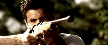 Movie still from “All the Boys Love Mandy Lane” (2006), directed by Jonathan Levine – A man is holding a rifle and aiming at something; Extreme Close Up shot, Low angle
