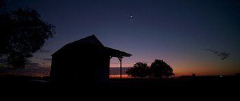 Movie still from “All the Boys Love Mandy Lane” (2006), directed by Jonathan Levine – The sun is setting over a field with a barn; Extreme Wide shot, Low angle
