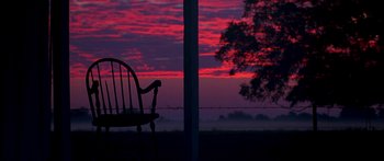 Movie still from “All the Boys Love Mandy Lane” (2006), directed by Jonathan Levine – A rocking chair sitting in front of a sunset; Wide shot, Low angle