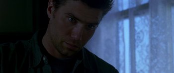 Movie still from “All the Boys Love Mandy Lane” (2006), directed by Jonathan Levine – Close up of a man's face in a dark room; Close Up shot, Over the shoulder angle