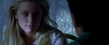 Movie still from “All the Boys Love Mandy Lane” (2006), directed by Jonathan Levine – A woman sitting in front of a window looking at the camera; Close Up shot, Over the shoulder angle