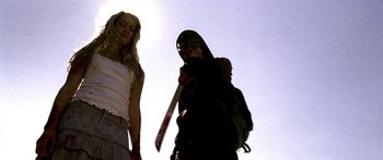 Movie still from “All the Boys Love Mandy Lane” (2006), directed by Jonathan Levine – A man holding a knife in front of a woman; Medium shot, Low angle