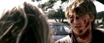 Movie still from “All the Boys Love Mandy Lane” (2006), directed by Jonathan Levine – A young boy with a bloody face is looking at a woman; Close Up shot, Over the shoulder angle