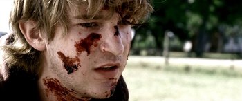Movie still from “All the Boys Love Mandy Lane” (2006), directed by Jonathan Levine – A person with blood on his face; Close Up shot, Over the shoulder angle