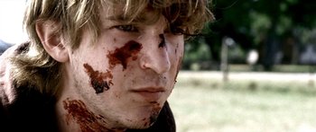 Movie still from “All the Boys Love Mandy Lane” (2006), directed by Jonathan Levine – A person with blood on his face; Close Up shot, Low angle