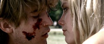 Movie still from “All the Boys Love Mandy Lane” (2006), directed by Jonathan Levine – A man and a woman face to face with blood on their faces; Extreme Close Up shot, Over the shoulder angle