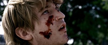 Movie still from “All the Boys Love Mandy Lane” (2006), directed by Jonathan Levine – A young man with blood all over his face; Extreme Close Up shot, Over the shoulder angle