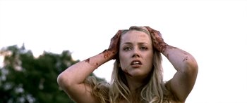 Movie still from “All the Boys Love Mandy Lane” (2006), directed by Jonathan Levine – A beautiful blonde woman holding her hands up to her face; Close Up shot, Low angle