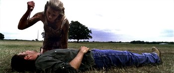 Movie still from “All the Boys Love Mandy Lane” (2006), directed by Jonathan Levine – A man laying in the grass next to a woman; Medium shot, Over the shoulder angle