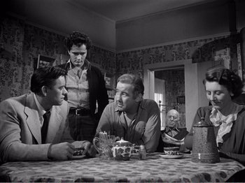 Movie still from “All the King's Men” (1949), directed by Robert Rossen – A black and white photo of people sitting at a dinner table; Medium shot, Over the shoulder angle