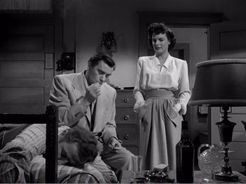 Movie still from “All the King's Men” (1949), directed by Robert Rossen – A man and a woman standing next to each other in a room; Medium shot, Low angle