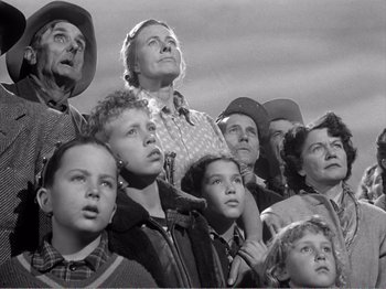 Movie still from “All the King's Men” (1949), directed by Robert Rossen – A group of people that are looking up at the sky; Medium shot, Low angle
