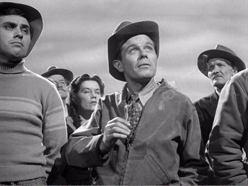 Movie still from “All the King's Men” (1949), directed by Robert Rossen – An old photo of a group of people standing together; Medium shot, Low angle