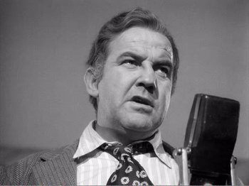 Movie still from “All the King's Men” (1949), directed by Robert Rossen – An old photo of a man with a microphone; Close Up shot, Low angle
