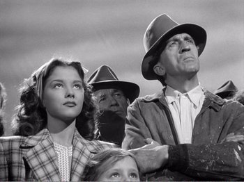 Movie still from “All the King's Men” (1949), directed by Robert Rossen – A black and white photo of a group of people; Medium shot, Low angle