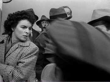 Movie still from “All the King's Men” (1949), directed by Robert Rossen – A group of people wearing hats and jackets; Medium shot, Over the shoulder angle